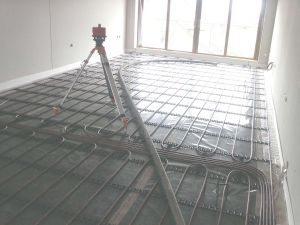 Re-checking the floor levels and preparing to pump the liquid floor screed over the underfloor heating loops.
