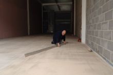 Surveying the site after screeding to check the surface regularity.